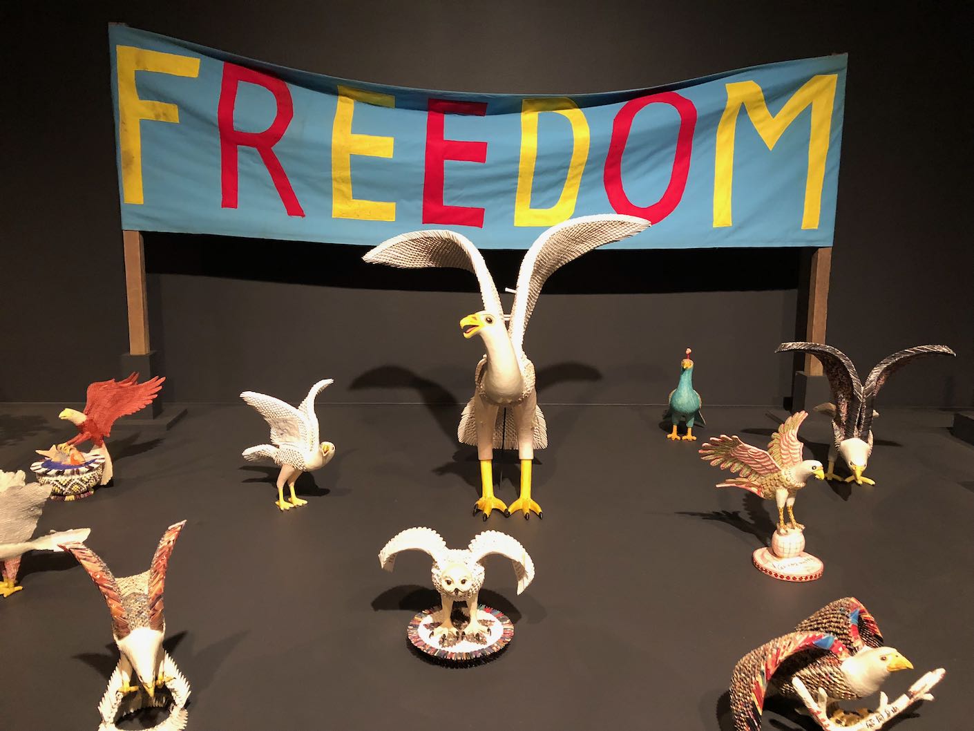 Models of birds in front of a banner reading 'Freedom'.