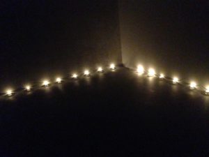 Tea lights illuminate a corner of the room.